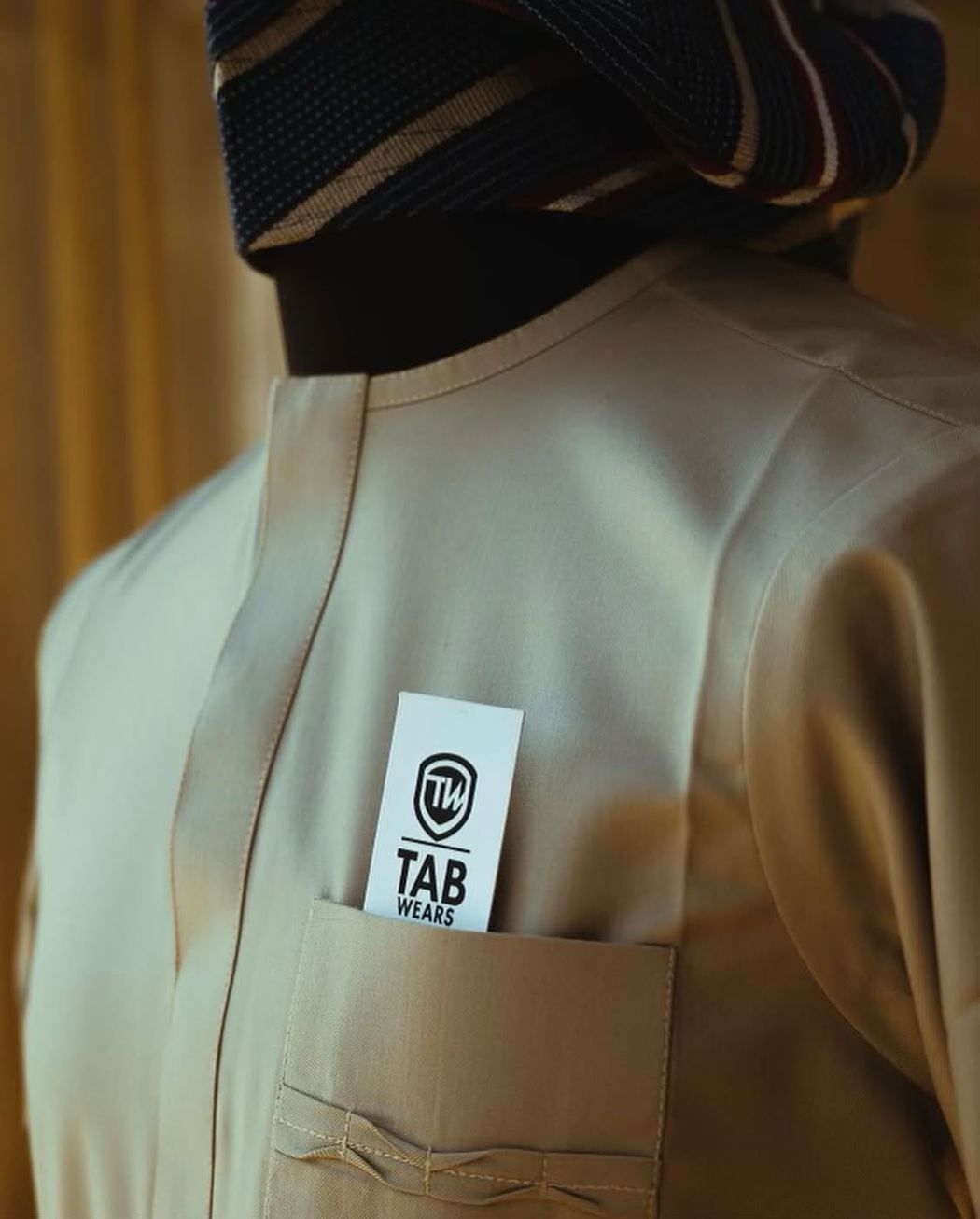 Champagne TAB senator with a striped fila on a tailor's form