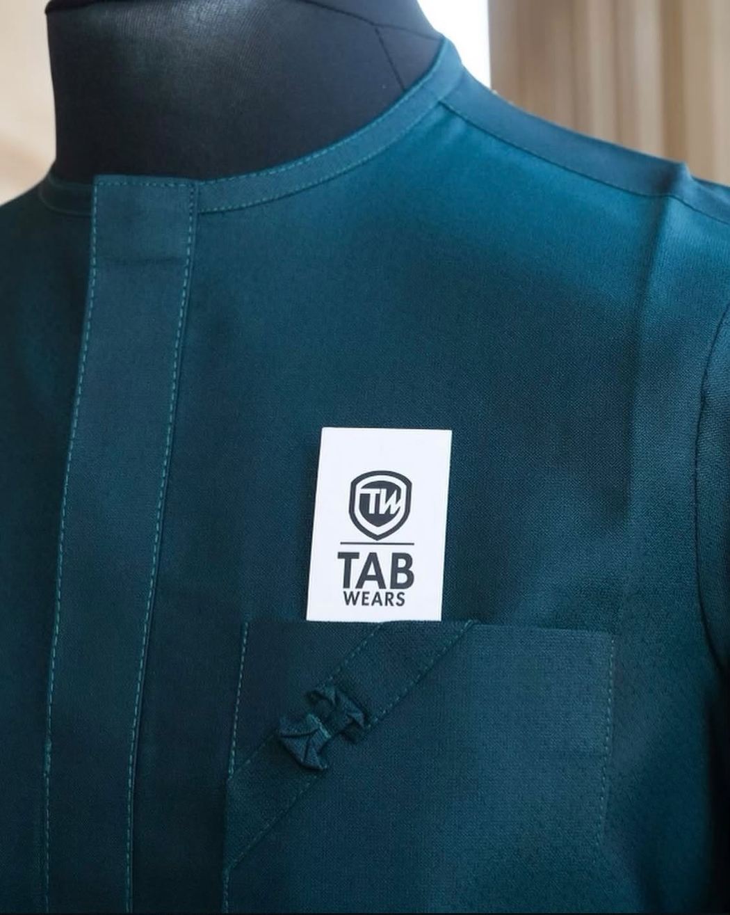 Close detail of a teal TAB senator pocket with knotted trim