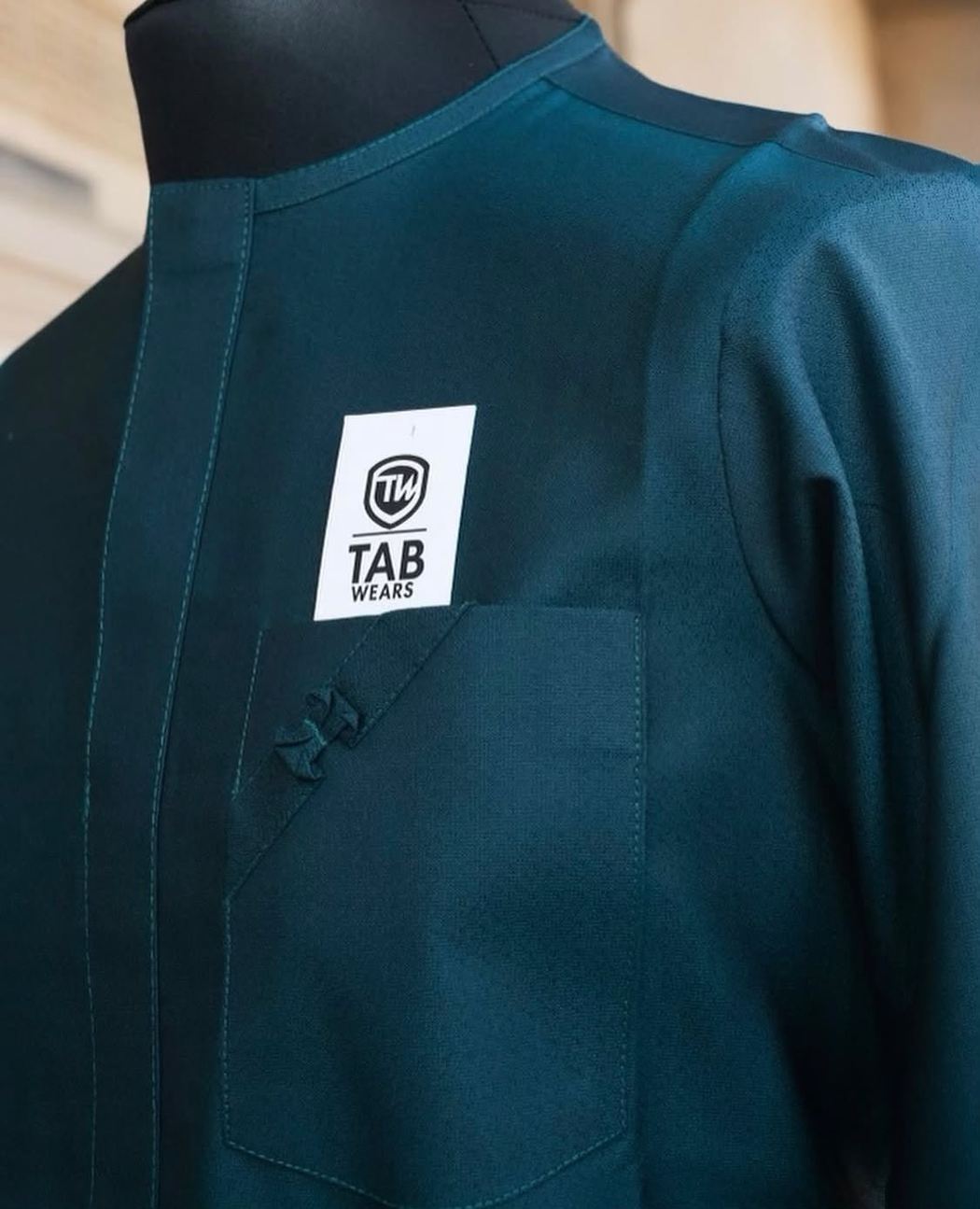 Teal TAB senator on a tailor's form showing the placket and shoulder
